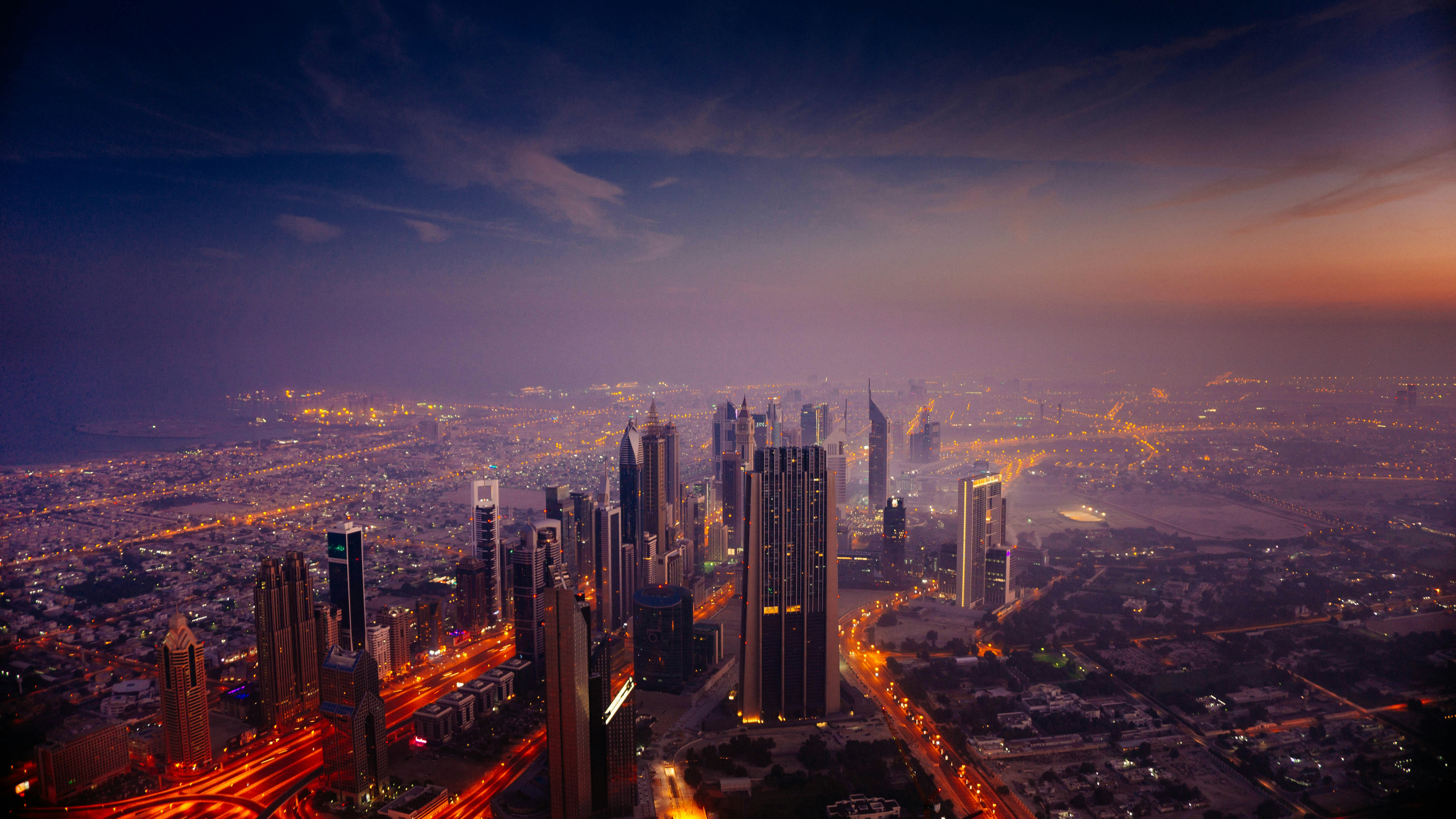 City skyline at dusk with lit buildings